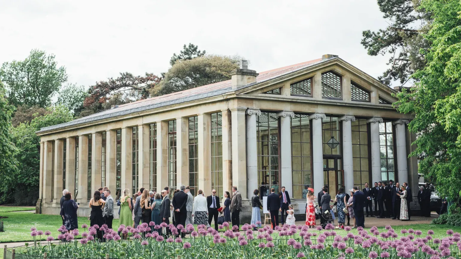Wedding guests outside a conservatory