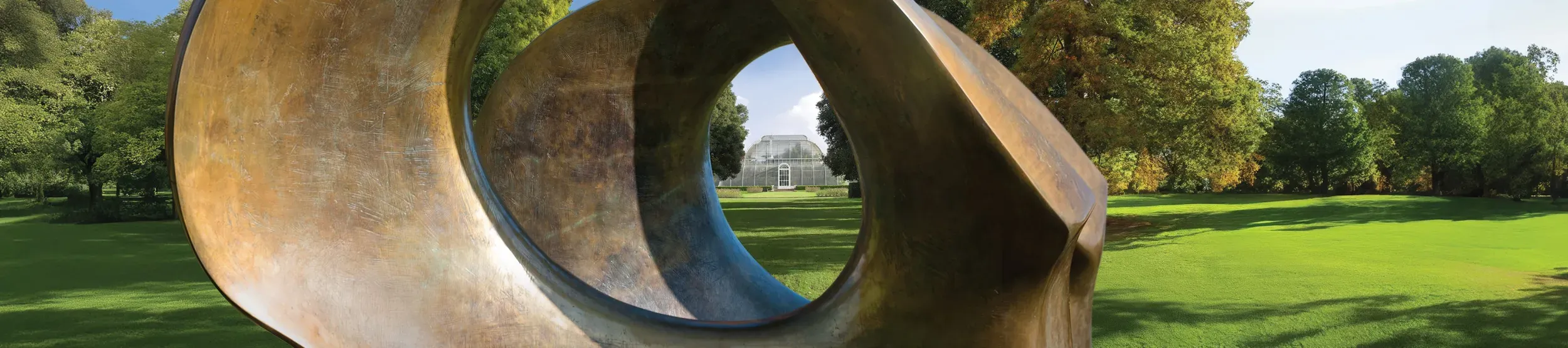 view of the palm house through the double oval sculpture