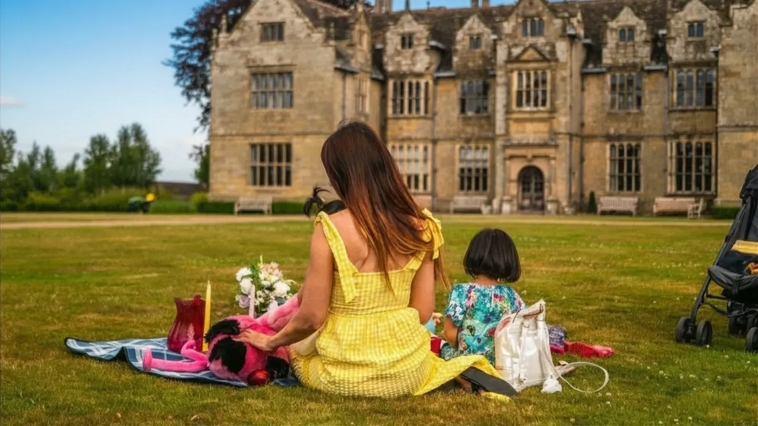 Mother and children having picnic in front of Wakehurst Mansion