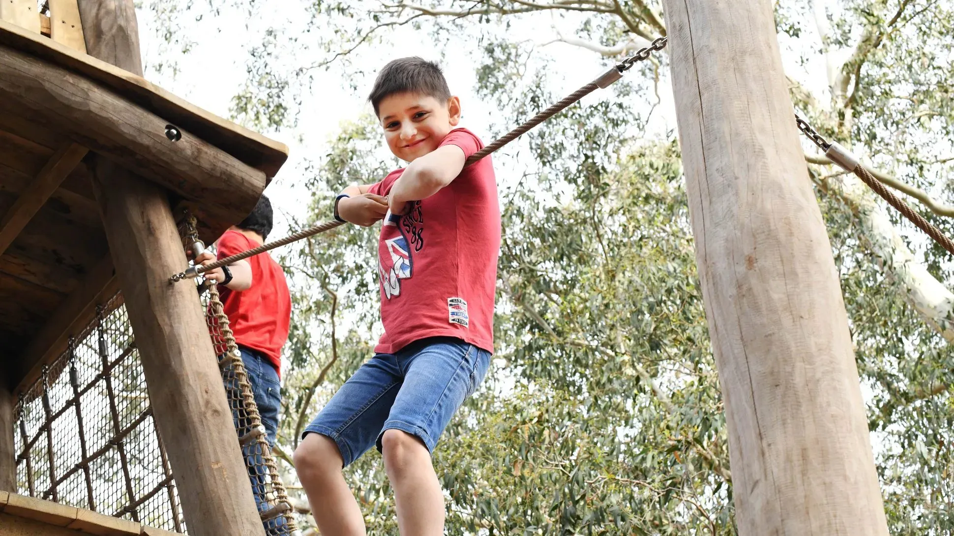 A young boy playing in the Children's Garden at Kew Gardens