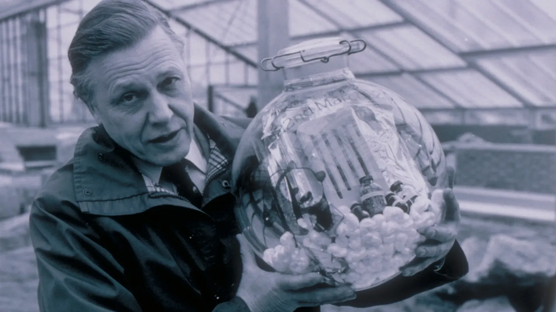 Sir David Attenborough holding a time capsule before it was buried in the foundations of the Princess of Wales Conservatory 