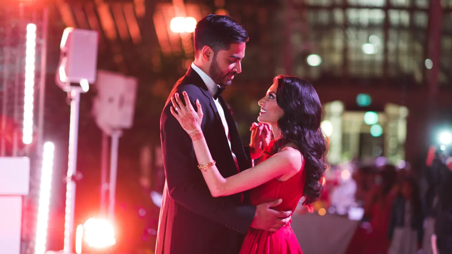 A couple dancing in the temperate house at night