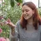 Digitisation Officer Eloise poses with pink flowers