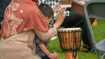 Woman and child drumming on the djembe