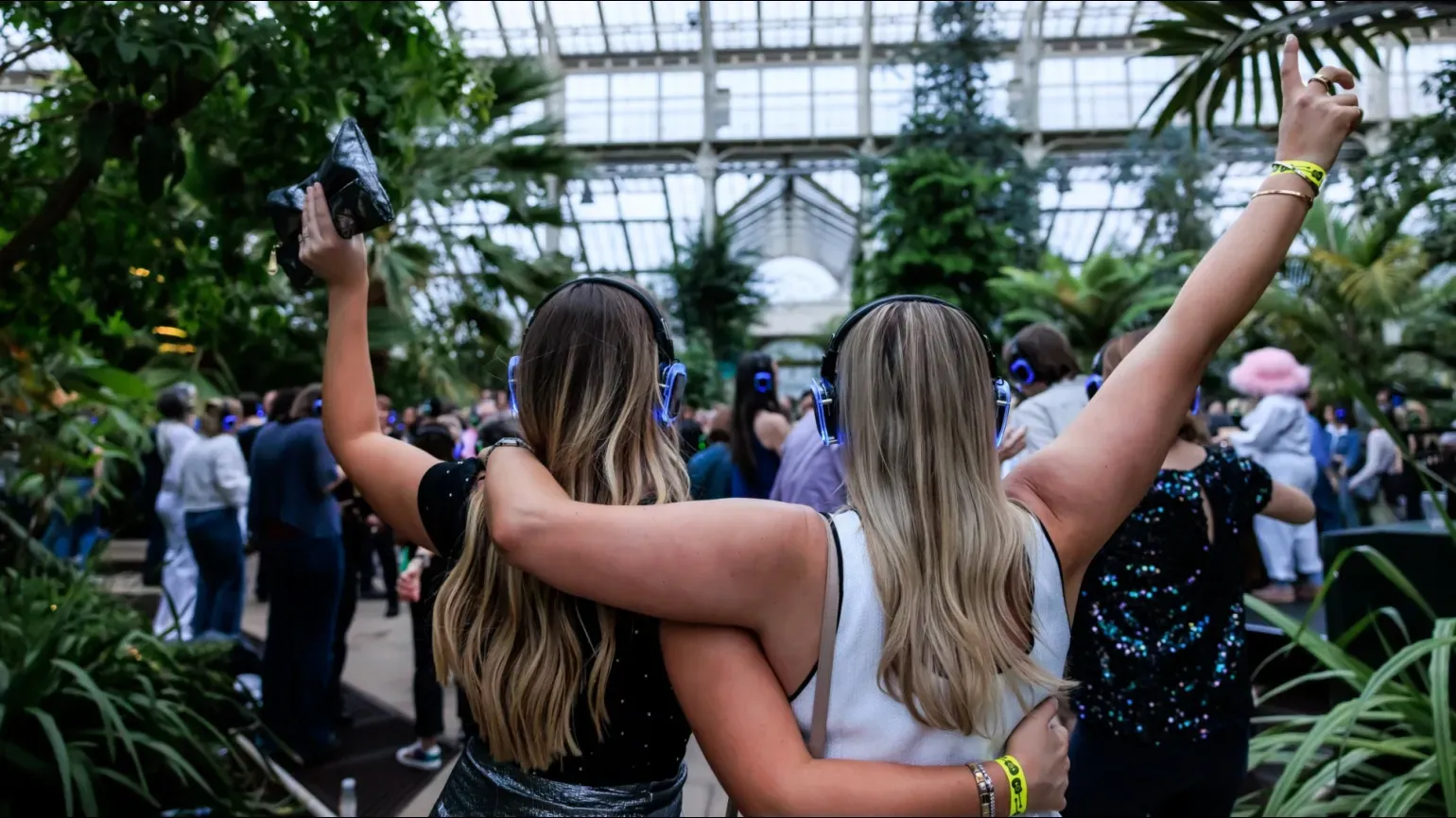 A pair of people dancing in the Temperate House at Kew Gardens Silent Disco