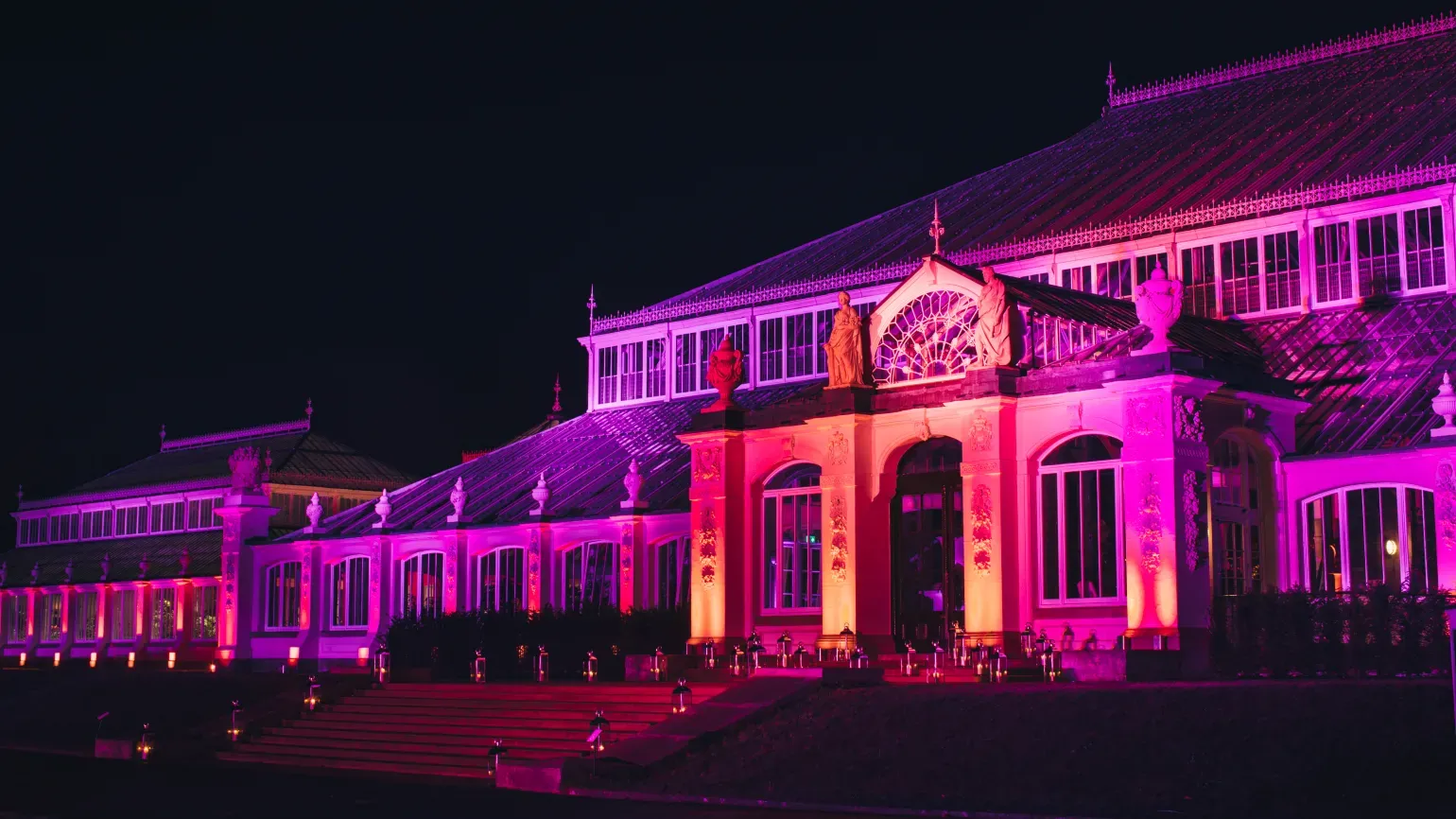 The Temperate House illuminated in purpleat night 