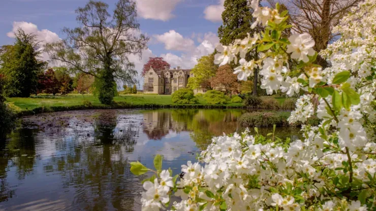 The Mansion pond at Wakehurst on a bright spring day 