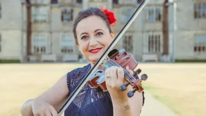 Violinist in front of Wakehurst Mansion